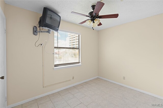 1500 W Beach Blvd Unit 212, Gulf Shores, AL 36542 - empty room with a textured ceiling, a ceiling fan, and baseboards