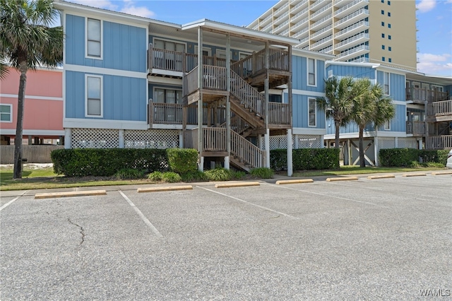 1500 W Beach Blvd Unit 212, Gulf Shores, AL 36542 - view of property featuring uncovered parking and stairway