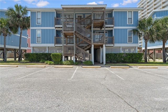 1500 W Beach Blvd Unit 212, Gulf Shores, AL 36542 - view of property with uncovered parking and stairway