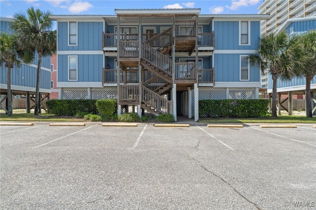 1500 W Beach Blvd Unit 212, Gulf Shores, AL 36542 - view of property with uncovered parking and stairway