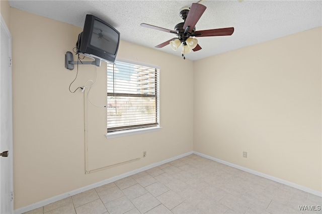 1500 W Beach Blvd Unit 212, Gulf Shores, AL 36542 - empty room with a textured ceiling, a ceiling fan, and baseboards