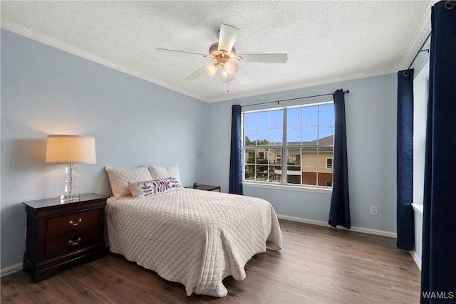 bedroom with crown molding, wood finished floors, baseboards, a textured ceiling, and a ceiling fan