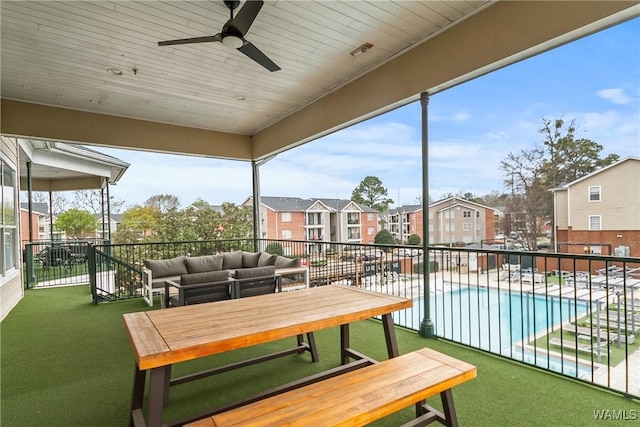balcony featuring an outdoor living space, a ceiling fan, and a residential view