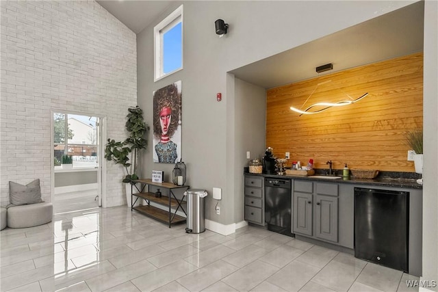 bar featuring refrigerator, high vaulted ceiling, baseboards, indoor wet bar, and black dishwasher