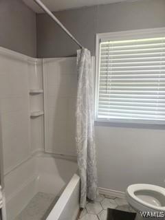 2417 Dvorak Cir, Linden, AL 36748 - full bath featuring plenty of natural light, shower / bath combo with shower curtain, and tile patterned flooring