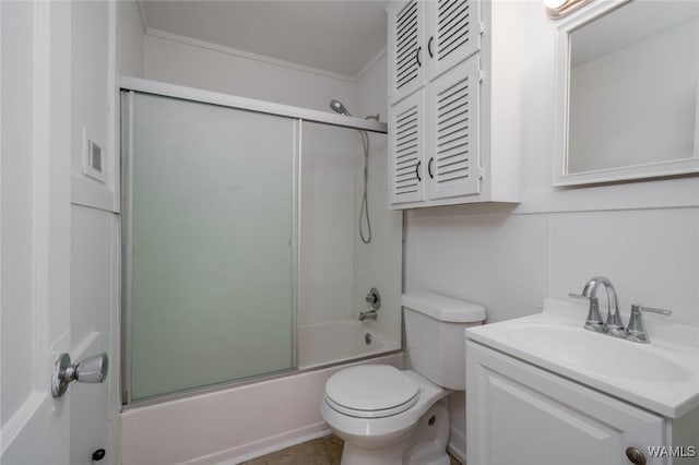 full bathroom featuring combined bath / shower with glass door, vanity, toilet, and crown molding