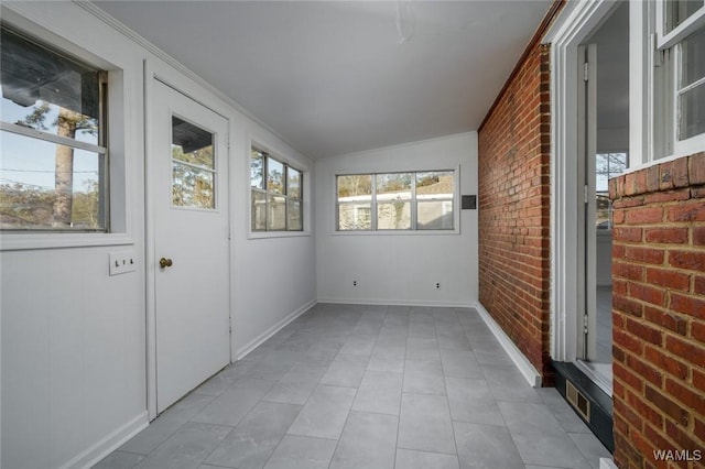 unfurnished sunroom with vaulted ceiling