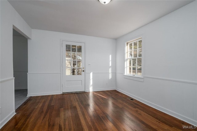 spare room with dark wood-type flooring