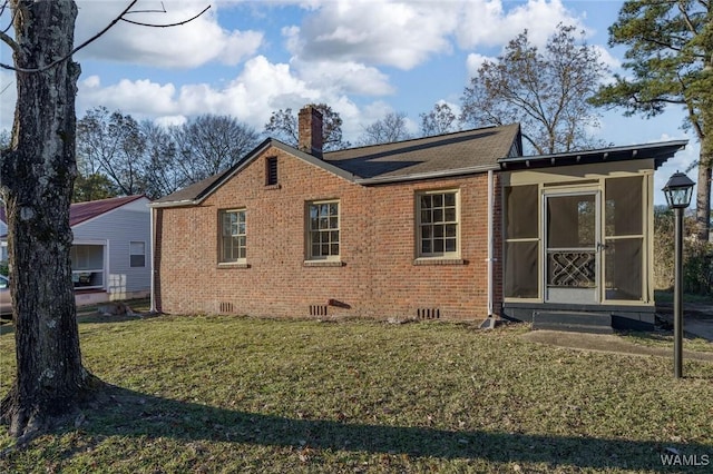 rear view of property featuring a yard