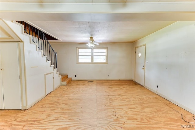 interior space with stairway and a ceiling fan