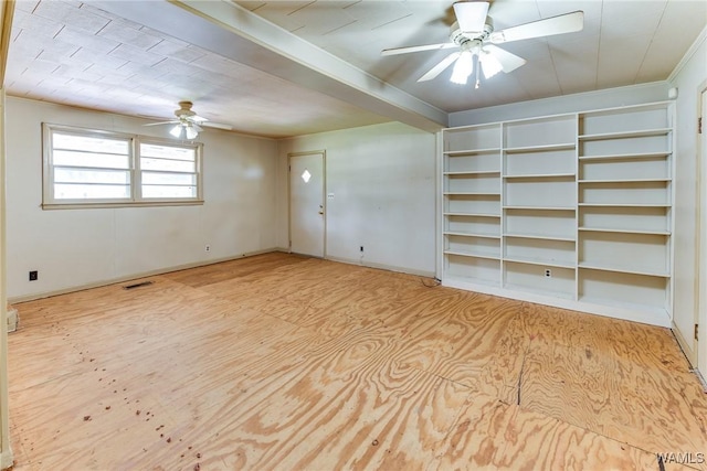 unfurnished room featuring visible vents, a ceiling fan, baseboards, and crown molding