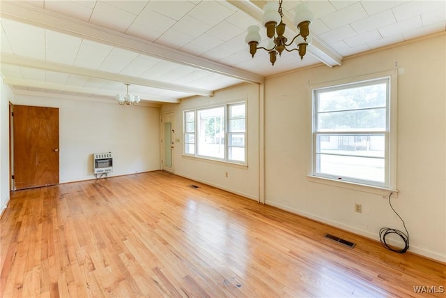 unfurnished living room featuring a chandelier, light wood-style flooring, heating unit, beamed ceiling, and visible vents