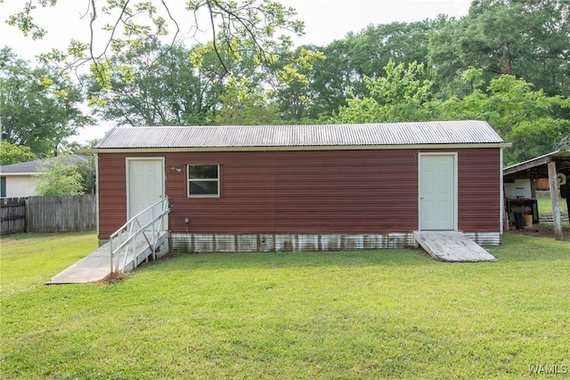 view of outbuilding with an outdoor structure and fence