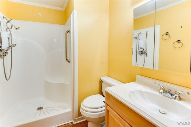 bathroom featuring toilet, walk in shower, ornamental molding, and vanity
