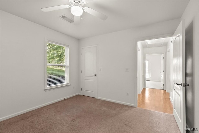 4713 Northwood Lake Dr E, Northport, AL 35473 - empty room featuring attic access, light colored carpet, a ceiling fan, and baseboards