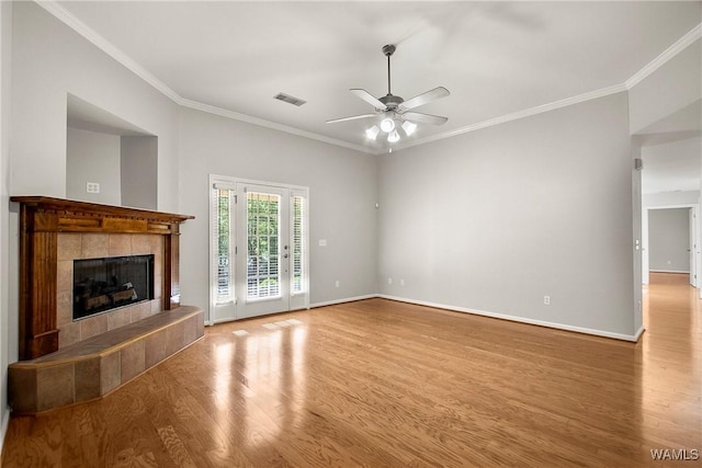4713 Northwood Lake Dr E, Northport, AL 35473 - unfurnished living room featuring wood finished floors, ceiling fan, crown molding, a tiled fireplace, and baseboards