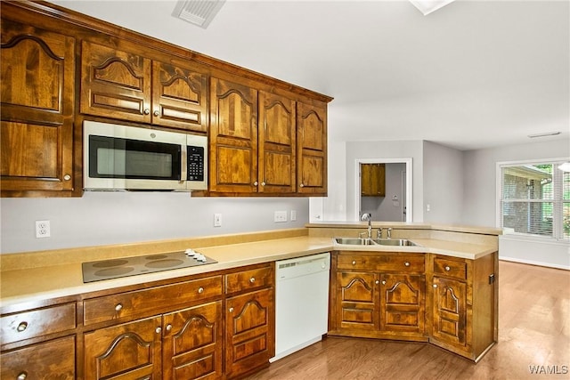 4713 Northwood Lake Dr E, Northport, AL 35473 - kitchen featuring stainless steel microwave, a sink, dishwasher, a peninsula, and electric cooktop