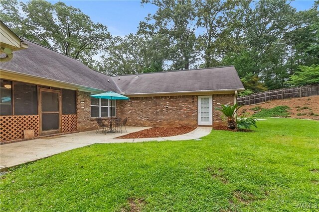 4713 Northwood Lake Dr E, Northport, AL 35473 - rear view of house with brick siding, a patio area, and roof with shingles