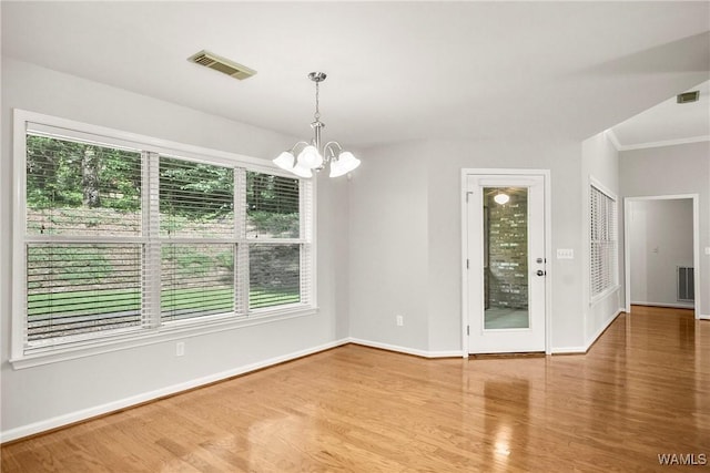 4713 Northwood Lake Dr E, Northport, AL 35473 - unfurnished room featuring a chandelier, wood finished floors, baseboards, and crown molding