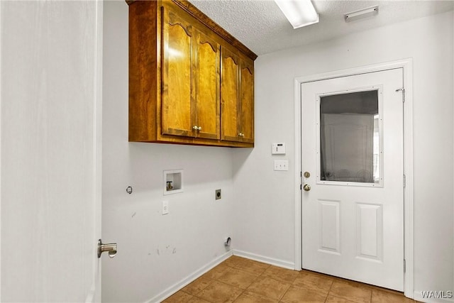 4713 Northwood Lake Dr E, Northport, AL 35473 - laundry room featuring hookup for an electric dryer, cabinet space, washer hookup, hookup for a gas dryer, and a textured ceiling