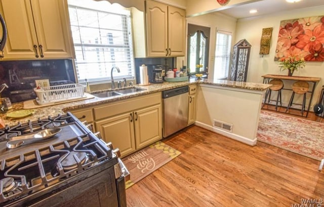 16584 Kathryn Lane Dr, Northport, AL 35475 - kitchen with stainless steel dishwasher, a sink, plenty of natural light, light wood finished floors, and recessed lighting