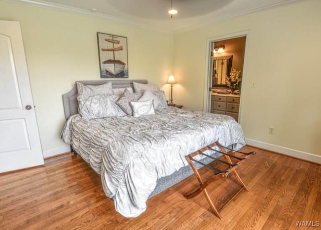 16584 Kathryn Lane Dr, Northport, AL 35475 - bedroom with wood finished floors, crown molding, baseboards, and connected bathroom