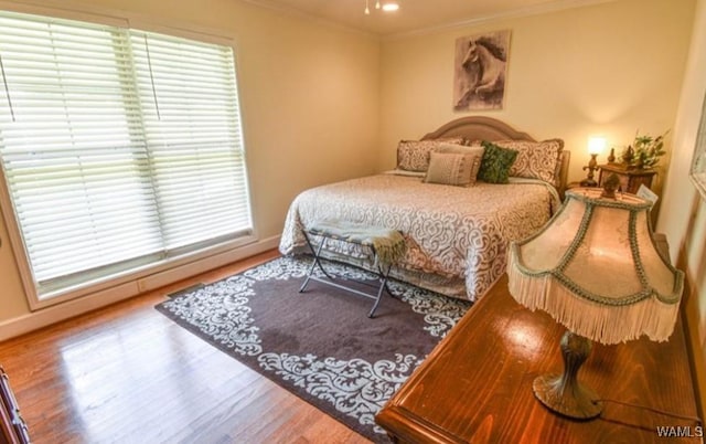 16584 Kathryn Lane Dr, Northport, AL 35475 - bedroom featuring crown molding, wood finished floors, and baseboards