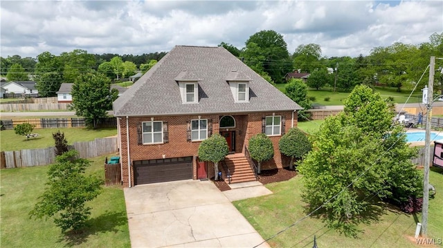 10821 Dogwood Cir, Vance, AL 35490 - view of front facade featuring driveway, an attached garage, brick siding, and a front yard