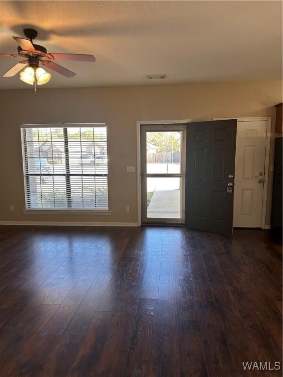 entryway with dark hardwood / wood-style floors and ceiling fan