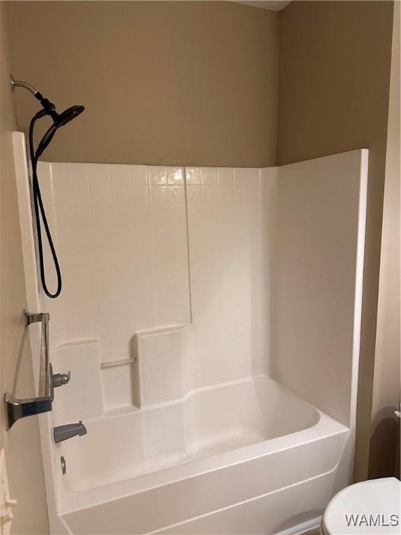 bathroom with toilet and bathtub / shower combination