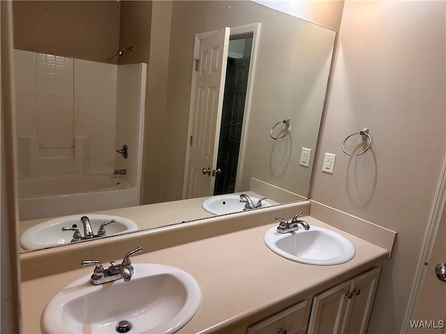 bathroom featuring vanity and  shower combination