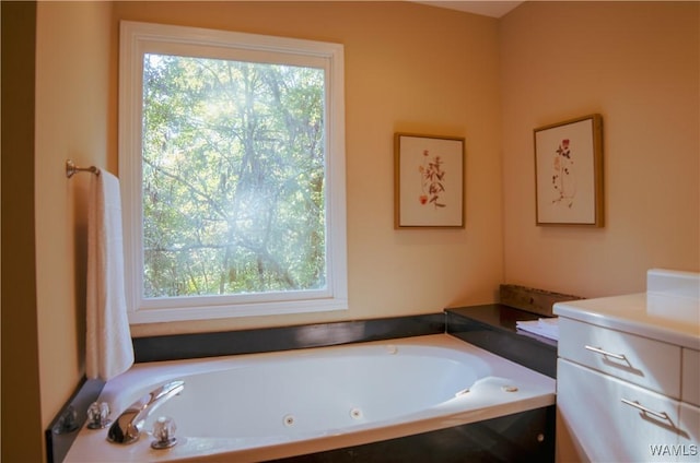 full bathroom with vanity and a tub with jets