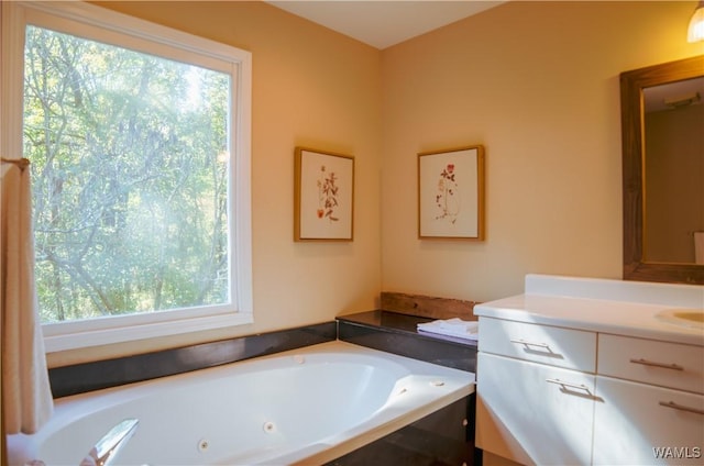 full bath featuring a jetted tub and vanity