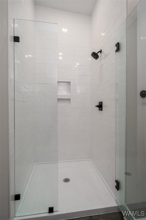 bathroom with a shower with door