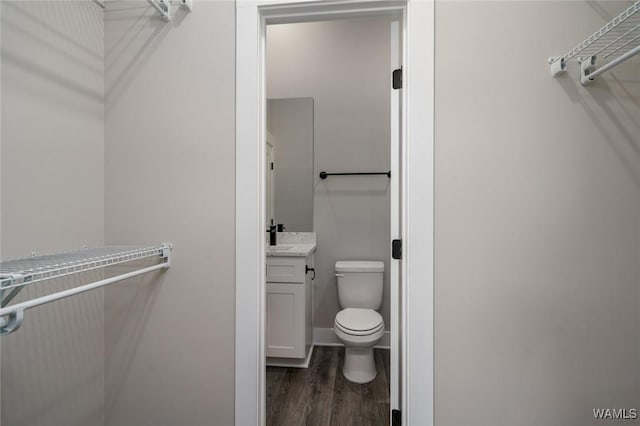 bathroom with vanity, hardwood / wood-style floors, and toilet