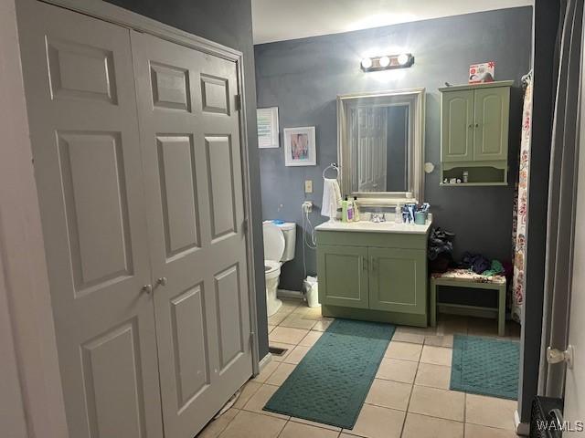 bathroom featuring toilet, tile patterned floors, and vanity