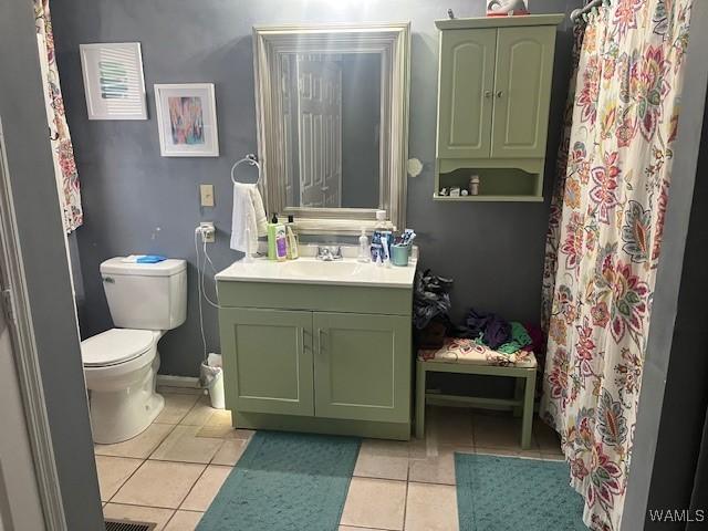 bathroom with tile patterned floors, vanity, and toilet