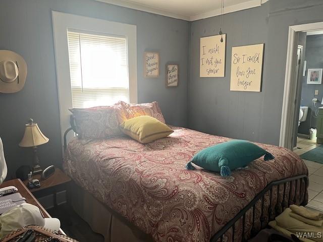 bedroom featuring crown molding and tile patterned floors