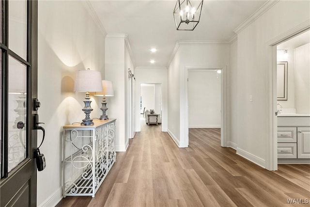 interior space with hardwood / wood-style floors, a notable chandelier, and ornamental molding