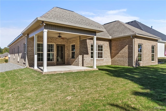 back of house featuring a lawn, ceiling fan, and a patio