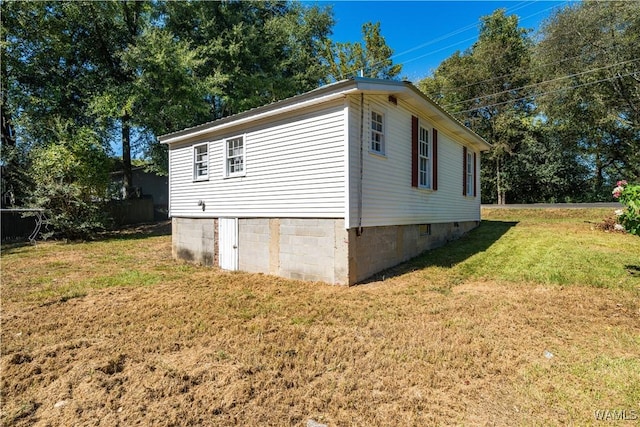 view of home's exterior featuring a yard and crawl space