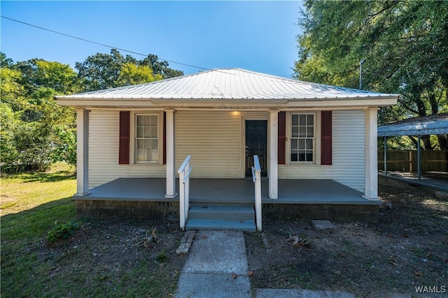 bungalow-style house with covered porch and metal roof