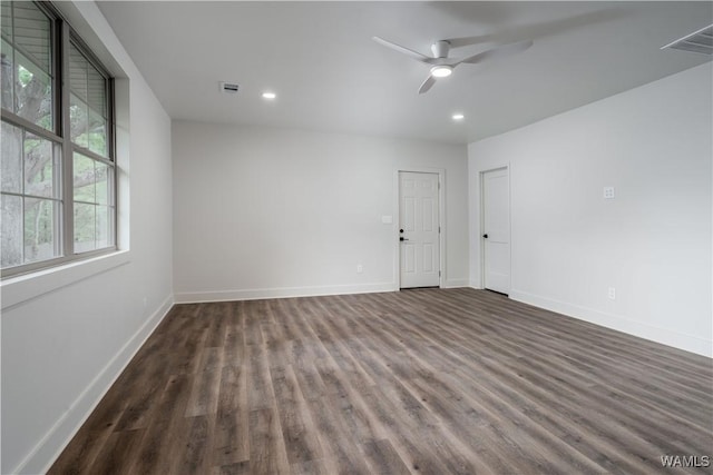 spare room with wood finished floors, a ceiling fan, baseboards, and recessed lighting