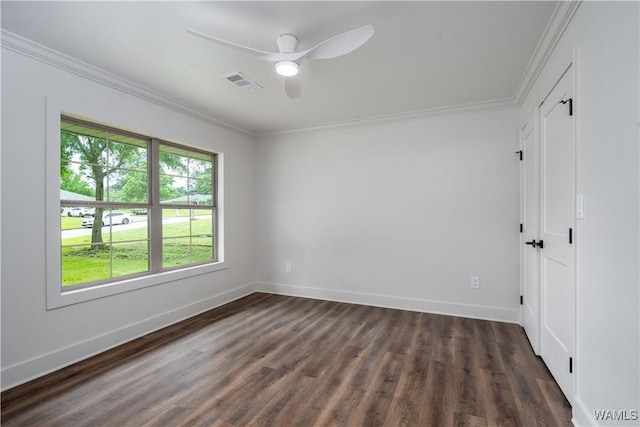 unfurnished bedroom with dark wood-style floors, crown molding, baseboards, and a ceiling fan