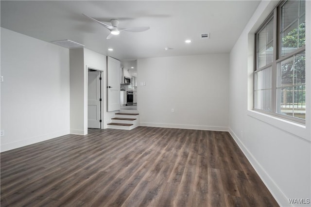 unfurnished living room featuring dark wood-style floors, healthy amount of natural light, ceiling fan, baseboards, and recessed lighting