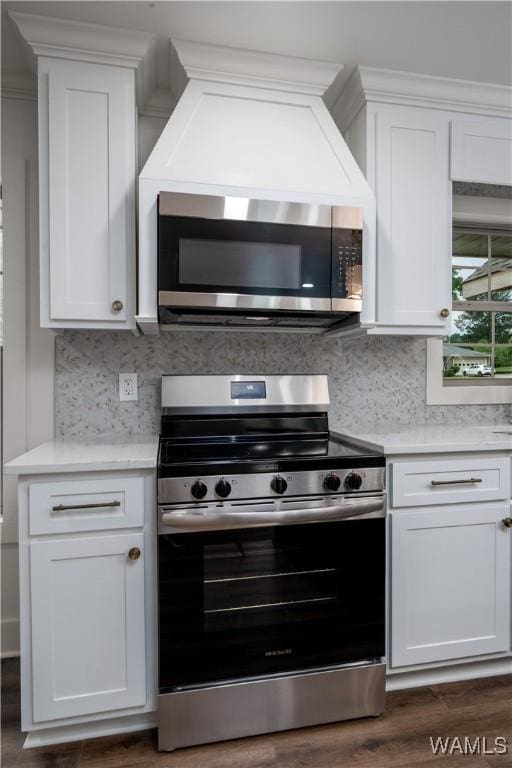 kitchen featuring stainless steel appliances, white cabinets, light countertops, and backsplash