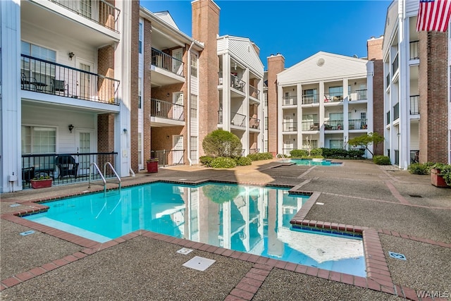 view of swimming pool featuring a patio area