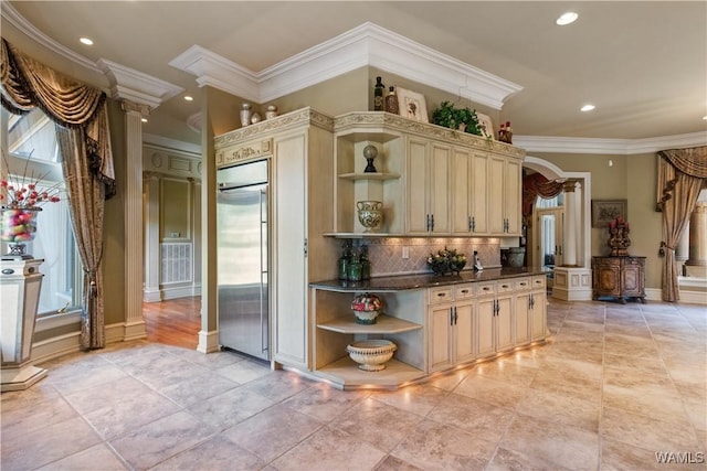 kitchen featuring tasteful backsplash, cream cabinets, stainless steel built in fridge, and crown molding