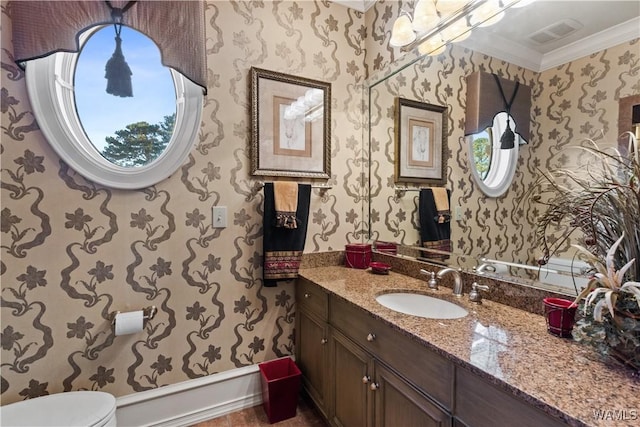 bathroom featuring vanity, toilet, and crown molding