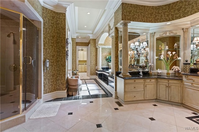 bathroom with vanity, tile patterned flooring, ornamental molding, walk in shower, and decorative columns